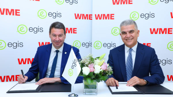 Laurent Germain, left, signs the deal with WME founder Peyman Mohajer (Egis)