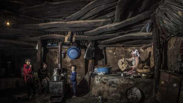 “Mother and her children” by Musa Talasli of Turkey shows a woman in Turkey preparing food for her family