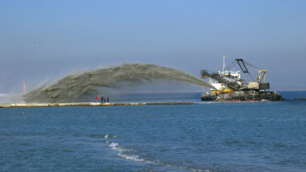 Dredgers suck up material from the sea floor and fire it from their sterns (Natallia Yaumenenka/Dreamstime.com)