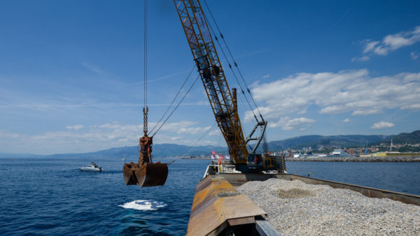 The first load of gravel for the 6.2km-long sea wall was poured on 5 May (Simone Buccarelli/Webuild)