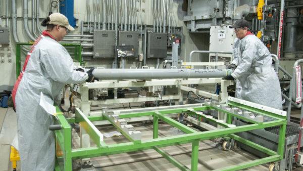 Workers load the last rocket containing GB nerve agent to be destroyed onto a loading rack in the Blue Grass plant (Courtesy of Bechtel)