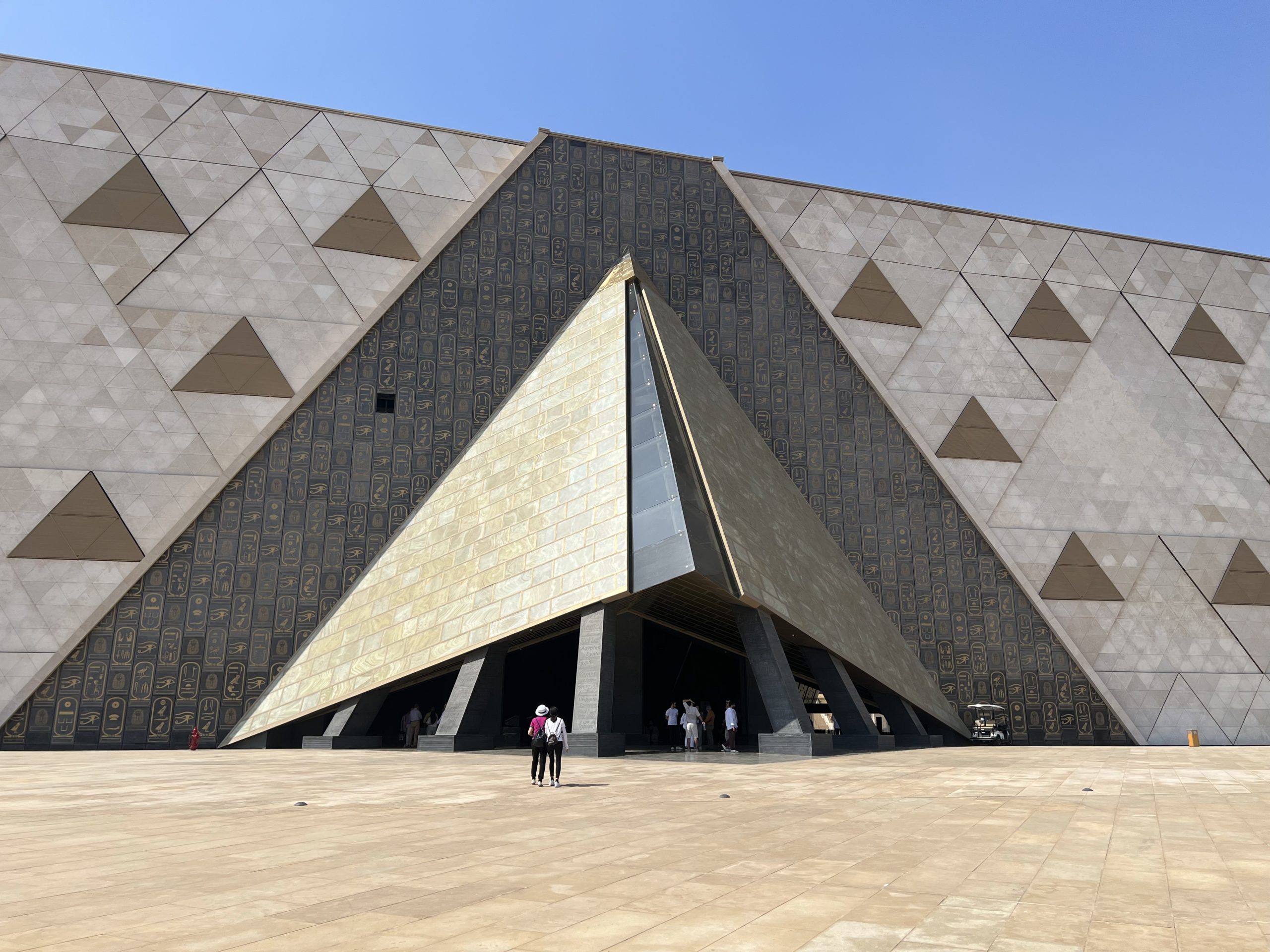 The Grand Egyptian Museum entrance creates the illusion of walking into a pyramid